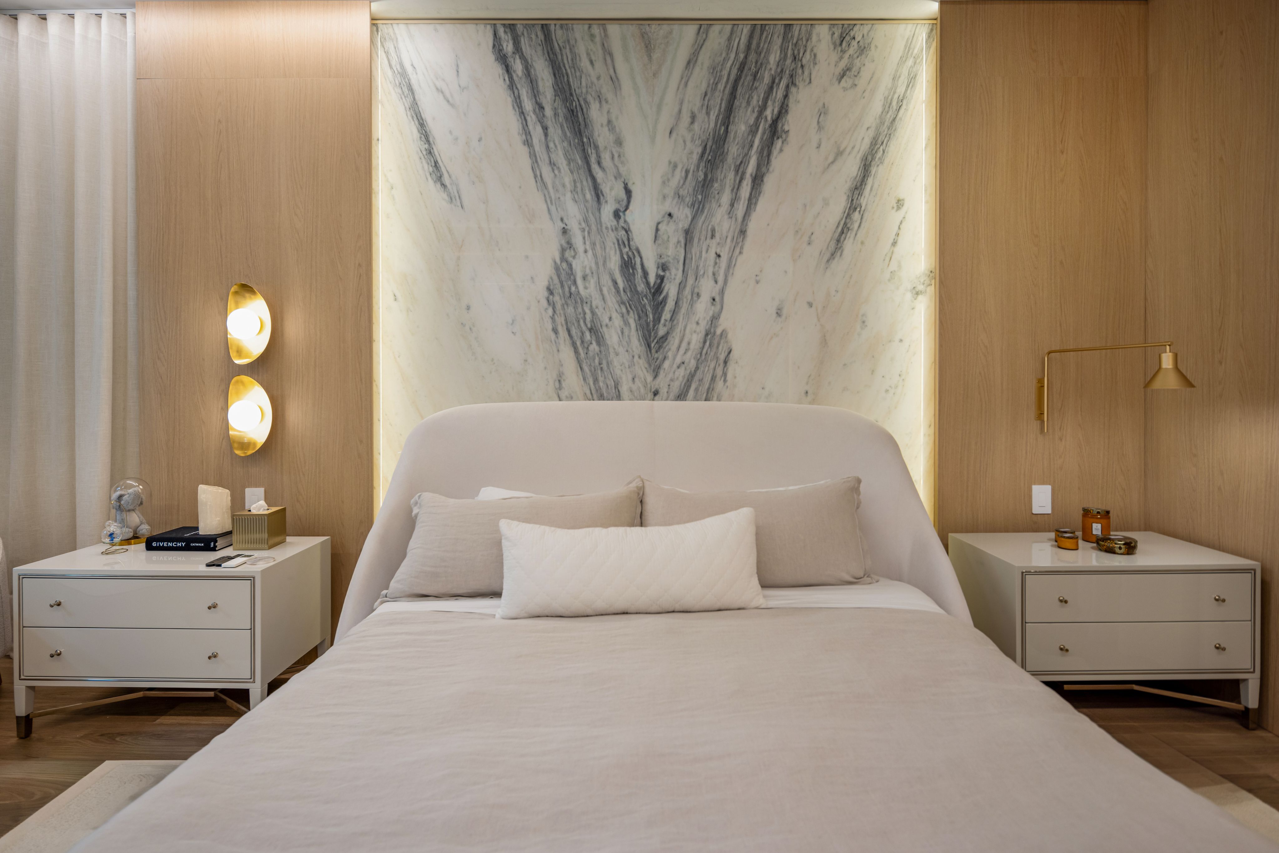 Book-matched marble headboard wall in the primary suite