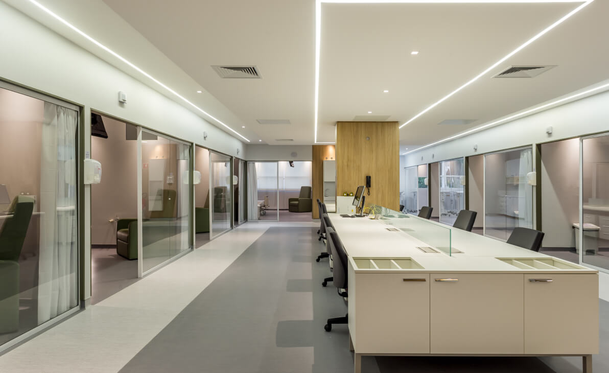 Healthcare facility corridor with glazed partitions