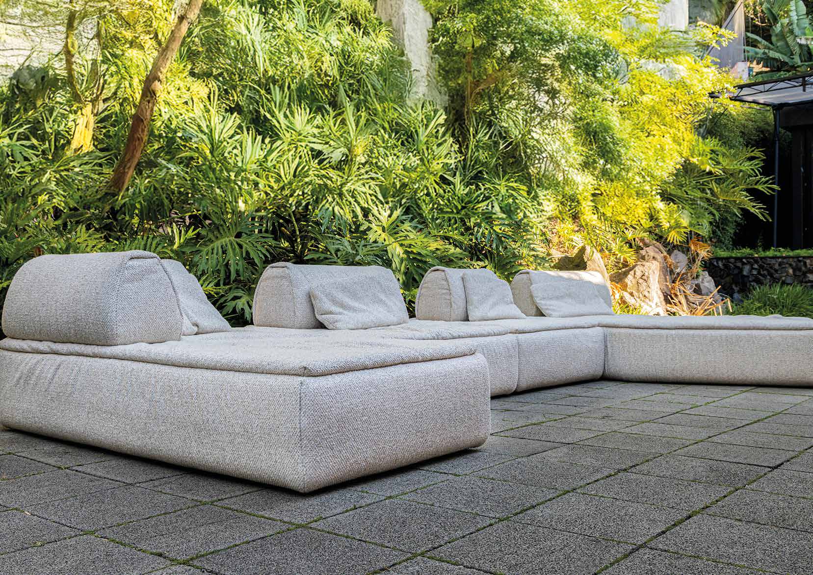 UULTIS outdoor modular sofa nestled in tropical greenery